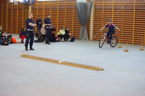 policjanci oceniają test sprawnościowy uczestnika w tle hala