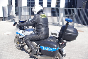 policjant na motocyklu w tle komenda