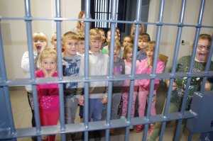 dzieci stoją za kratami policyjnego aresztu