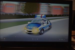 animowany radiowóz policyjny, w tle ulica