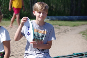 chłopiec trzyma piłkę plażową w tle jezioro