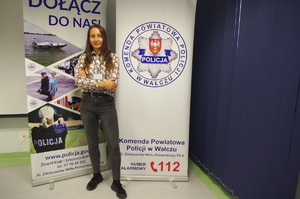 policjantka nieumundurowana w tle banery promujące jednostkę