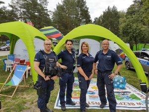 policjanci rozmawiają z dziećmi w tle namiot i policyjne gadżety
