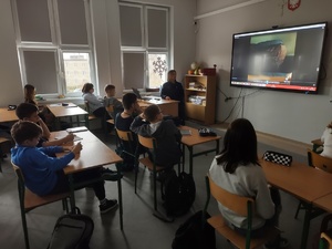 policjantka rozmawia z uczniami w tle wyposażenie sali