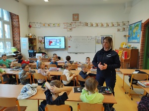 policjantka rozmawia z dziećmi w tle sala lekcyjna