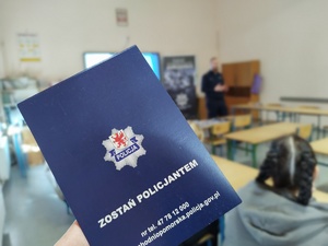policjant rozmawia z uczniami w tle wyposażenie sali lekcyjnej