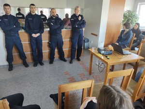 policjanci rozmawiają z licealistami w tle pomieszczenie świetlicy