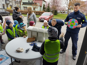 policjanci zabawiają dzieci zabawami edukacyjnymi w tle namiot policyjny i dzieci