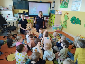 policjantki rozmawiają z dziećmi w tle wyposażenie sali i dzieci wraz z opiekunami