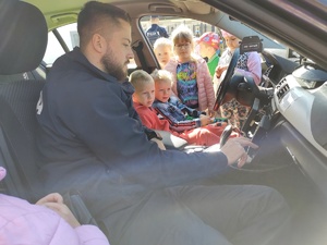 dzieci w towarzystwie policjantów zwiedzają komendę policji