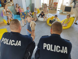 policjanci rozmawiają z dziećmi w tle wyposażenie sali