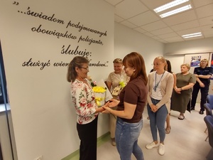 pracownicy składają życzenia w tle sala