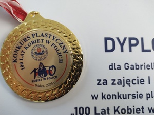 Komendant wręcza nagrody uczestnikom konkursu w tle baner