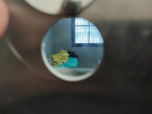 zatrzymany leży na łóżku w tle kraty