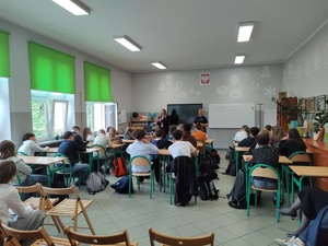 goście prowadzą spotkanie, w tle sala