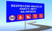 tablica na niebieskim tle umieszczony napis &quot;Bezpieczne wakacje fakty i mity na drodze&quot;.